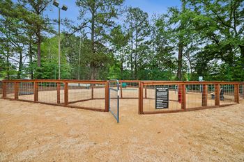 a fenced in area with trees in the background and a sign at Chapel View, Chapel Hill, NC 27516