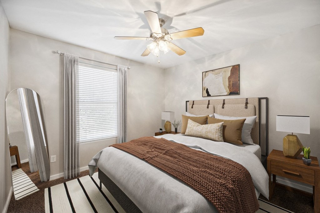 Bedroom with a Large Bed and a Ceiling Fan at 45 Madison Apartments, Missouri, 64111