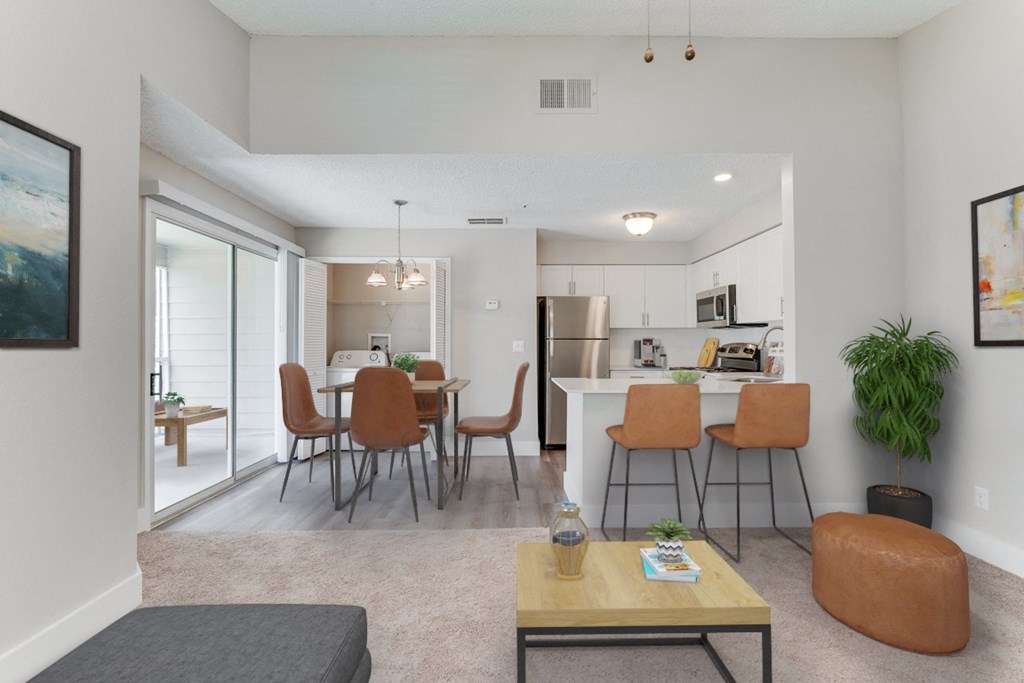living room  with kitchen at Palm Crossing Apartments in Winter Garden, FL
