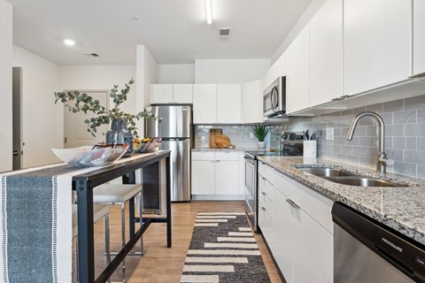a modern kitchen with white cabinets and stainless steel appliances at The Constellation Apartments, PRG Real Estate, Hampton, Virginia