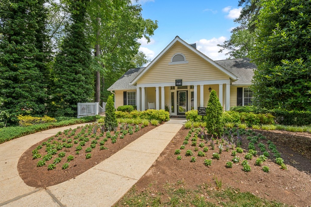 a house with a garden and a walkway in front of it