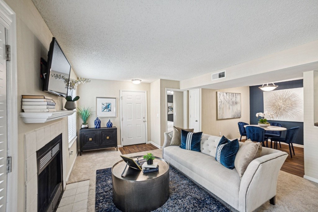 A living room with a fireplace and a couch at Willow Ridge Apartments, North Carolina, 28210