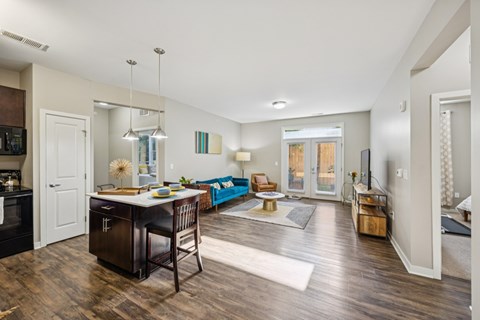 A kitchen with a dining table and chairs.
