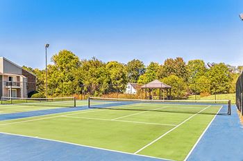 the tennis courts are equipped with a gazebo and gated tennis courts at The Grove at Lyndon, Louisville