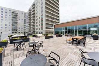an outdoor patio with tables and chairs  at South Falls Tower, Richmond, Virginia