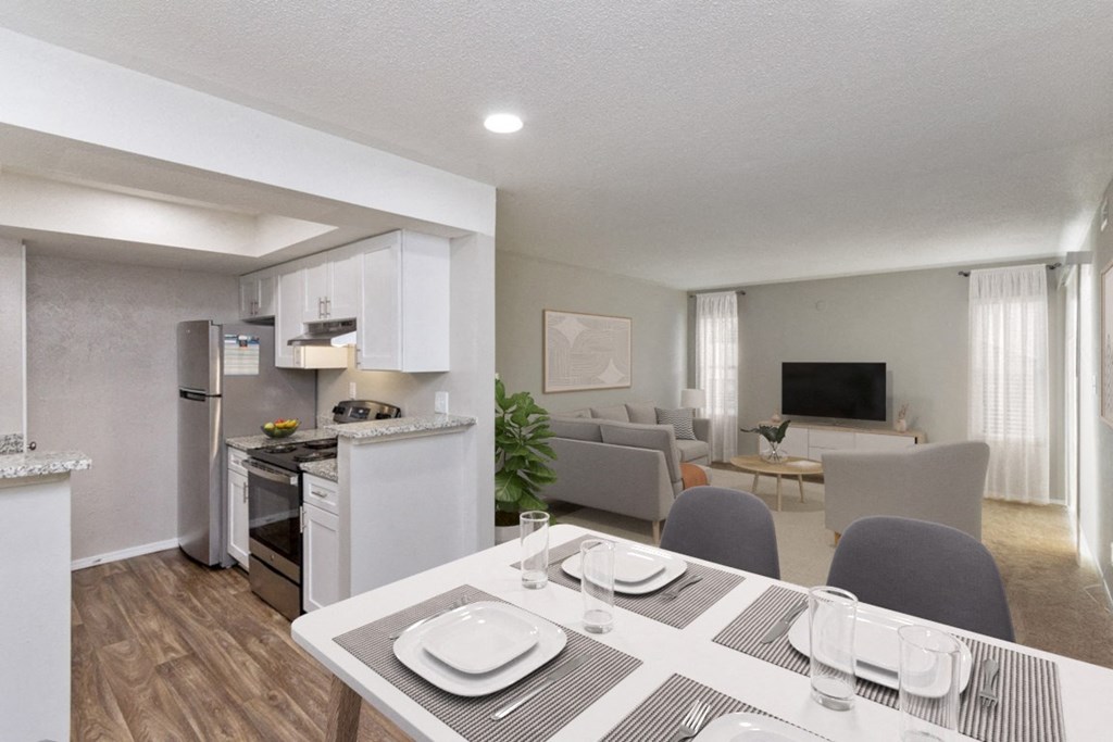 a kitchen and living room with a dining table and chairs