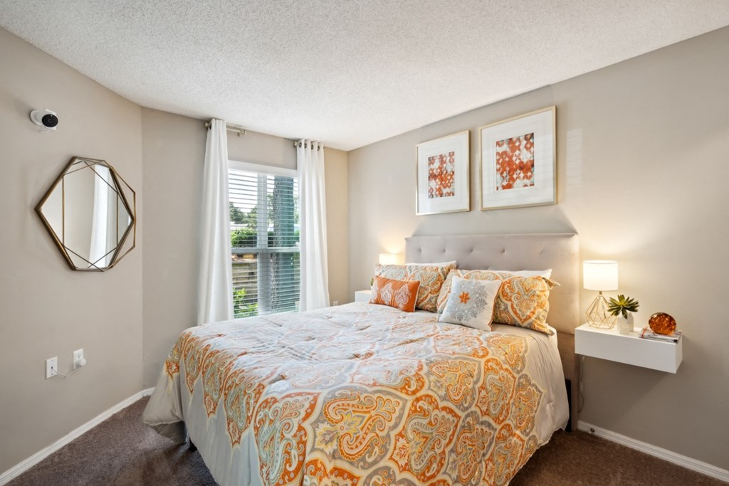 a bedroom with a bed and a window