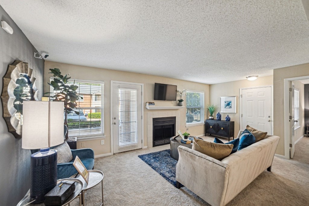 A living room with a fireplace and a couch at Willow Ridge Apartments, North Carolina, 28210