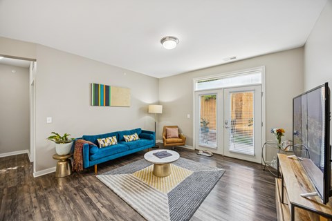 A living room with a blue couch and a television.