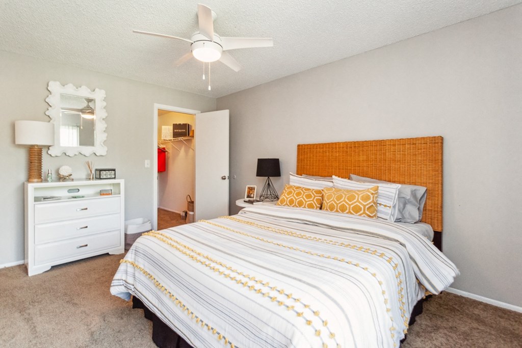 a bedroom with a large bed and a ceiling fan