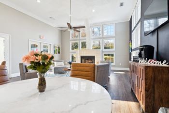 a living room with a table and a fireplace at Ashton Creek, Chester, VA