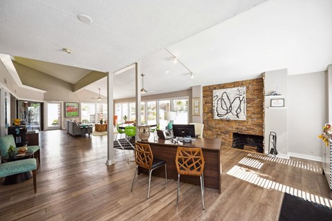 a living room with a table and chairs and a fireplace