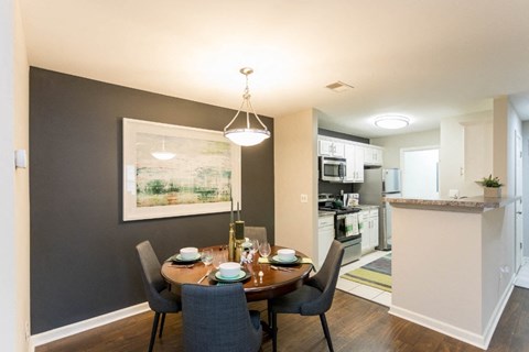 a dining room and kitchen with a table and chairs