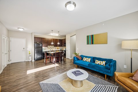 A living room with a blue couch and a coffee table.