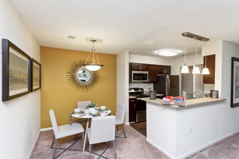 our apartments offer a kitchen and dining area with a table