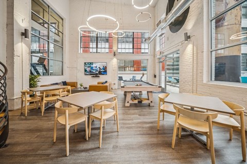 A modern dining area with wooden chairs and tables.