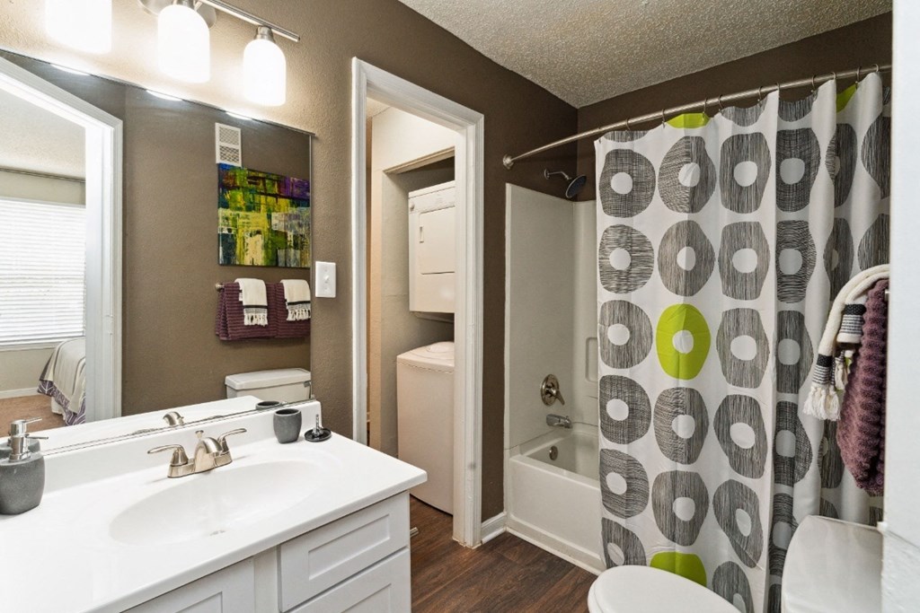 a bathroom with a shower and a sink and a toilet