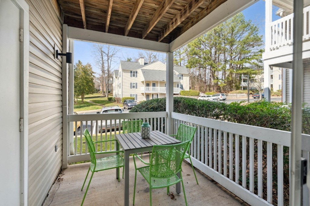 a patio with a table and chairs on a porch