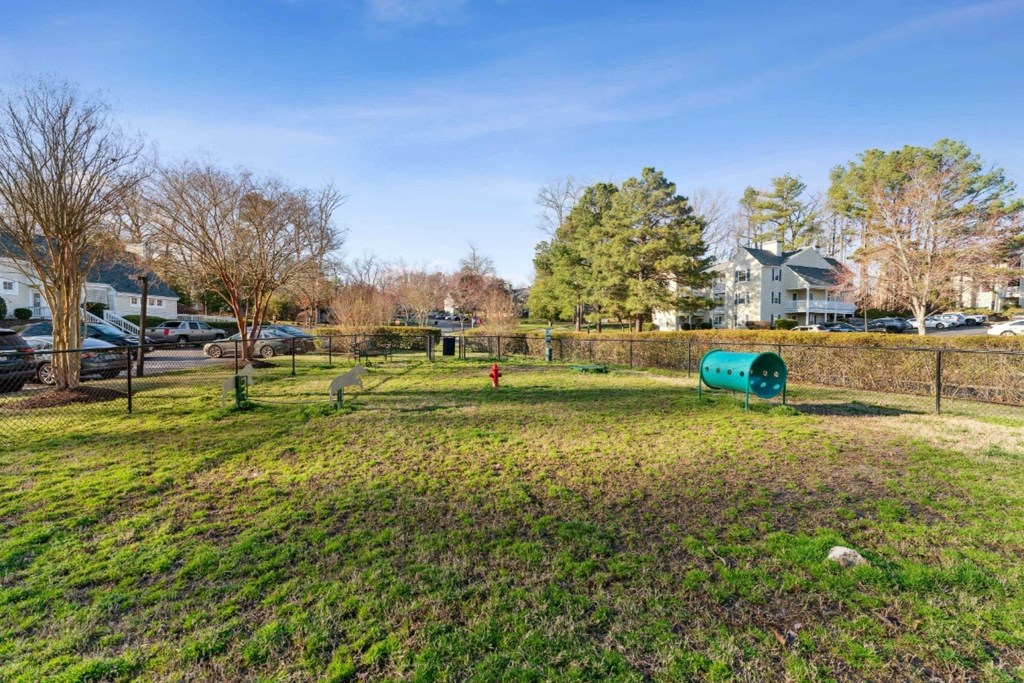 a park with a dog park and a fence