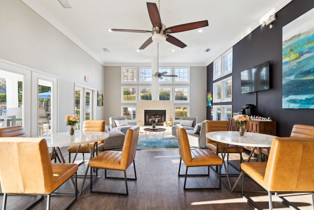 a living room with tables and chairs and a fireplace at Ashton Creek, Chester, VA