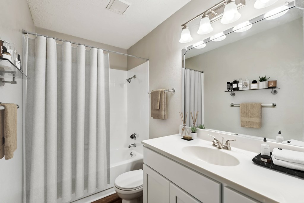 A modern bathroom with a white sink and a white toilet.at Chapel View, North Carolina, 27516