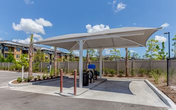 a covered parking area with a bike parked under a canopy at The Loree, Jacksonville, 32256
