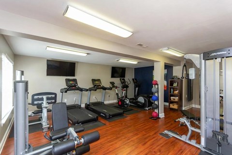 A well-equipped home gym with a variety of exercise machines at Clarion Crossing Apartments, PRG Real Estate Management, Raleigh