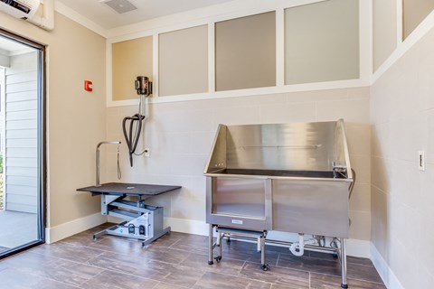 a kitchen with a stainless steel stove and a table