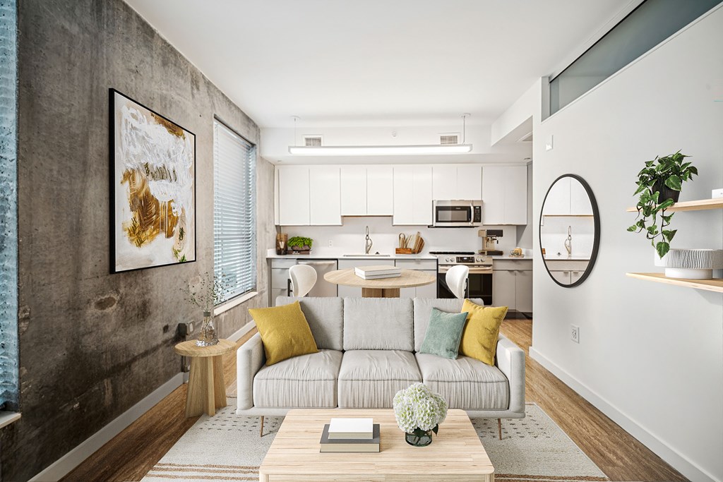 A modern living room with a grey couch and a coffee table.