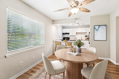 A dining room with a round table and chairs at Rivers Landing Apartments, Hampton, Virginia
