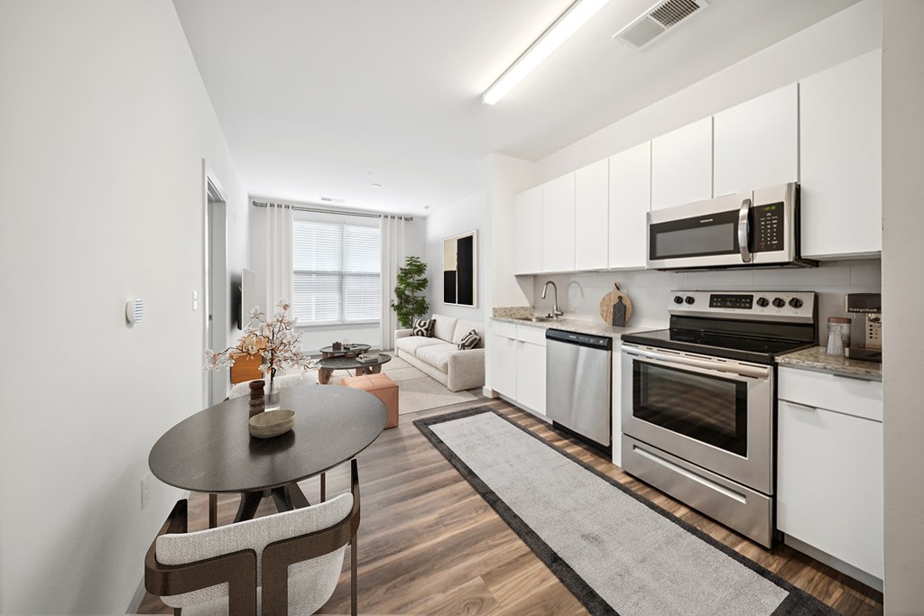 A modern kitchen with a dining table and chairs.