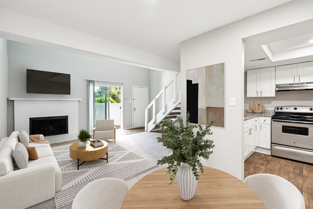 A modern living room with a fireplace and a television at Woodcreek Apartments, Cary, 27511