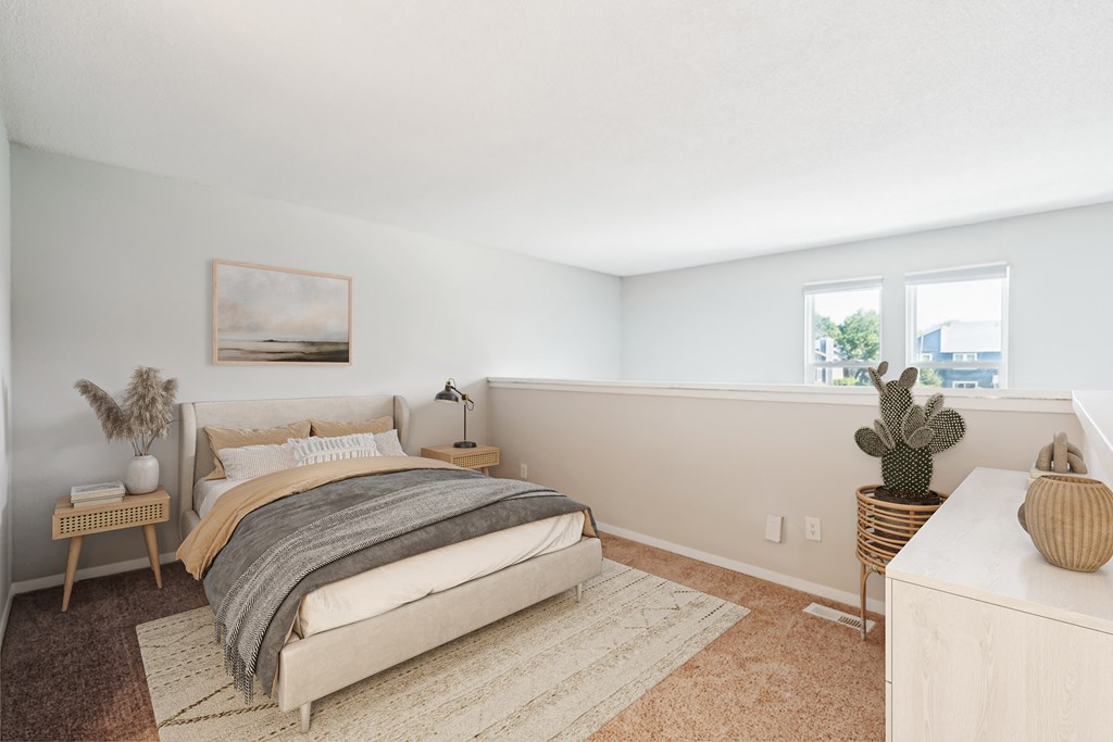 A bedroom with a large bed and a cactus on the side table at Woodcreek Apartments, Cary, 27511