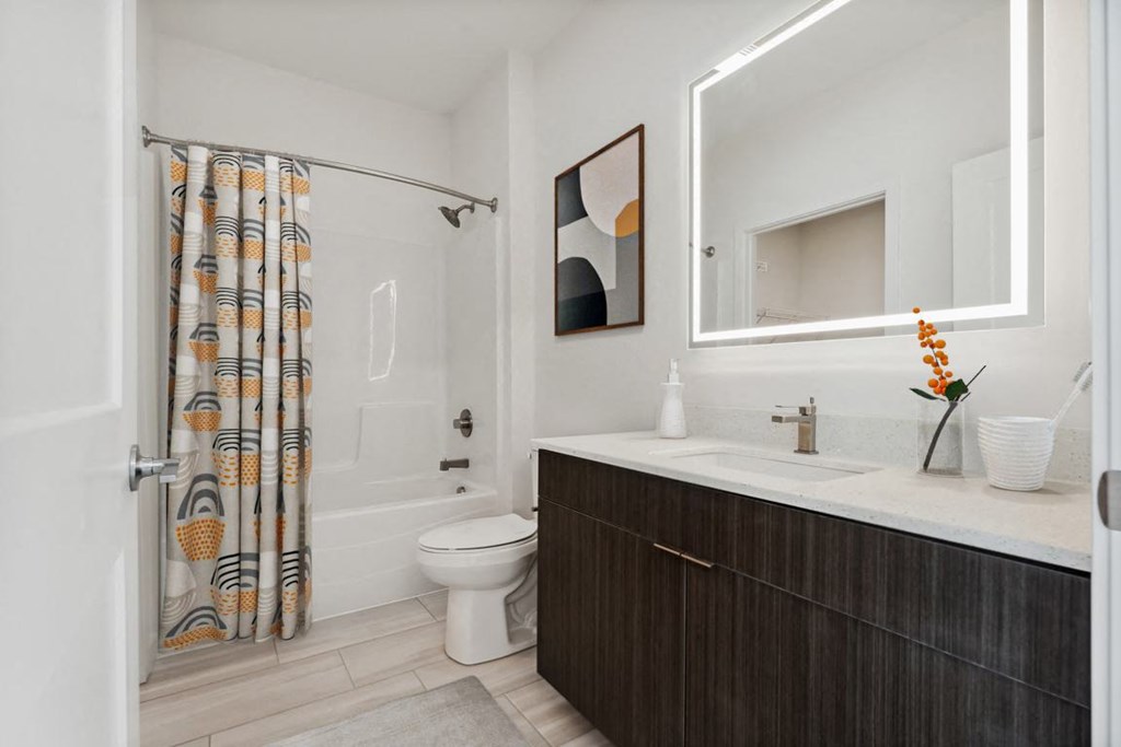 a bathroom with a toilet sink and shower