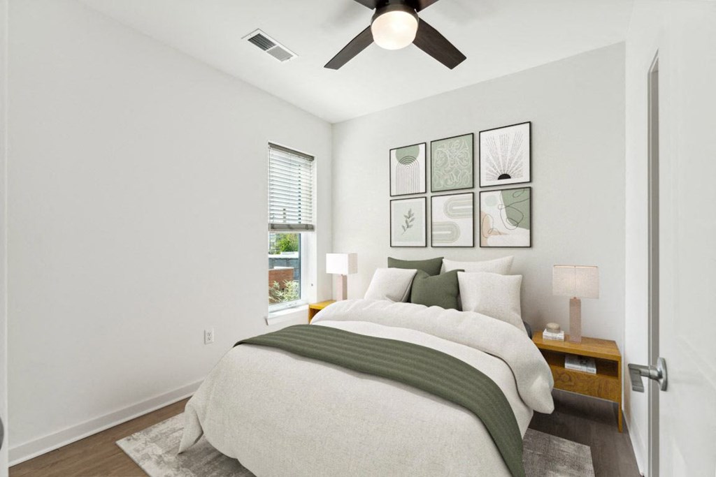 a bedroom with a large bed and a ceiling fan