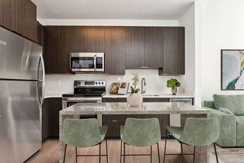 a kitchen with stainless steel appliances and a marble counter top