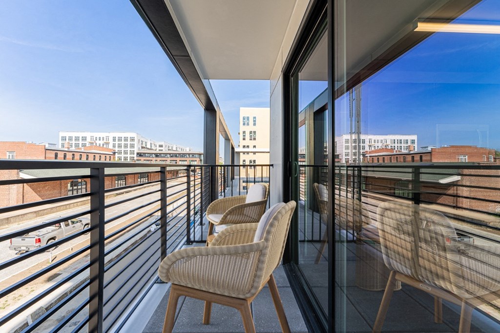 a balcony with chairs and a table
