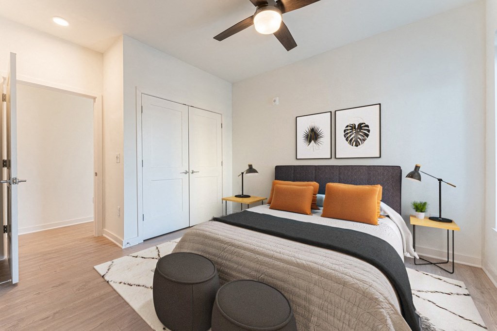 a bedroom with a large bed and a ceiling fan