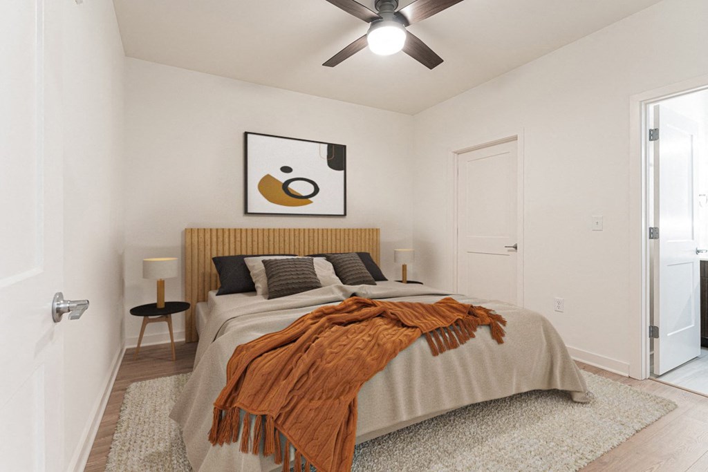 a bedroom with a large bed and a ceiling fan