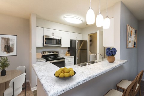 A kitchen with a marble countertop and a bowl of lemons on it at Palmetto Place Apartments in Taylors SC