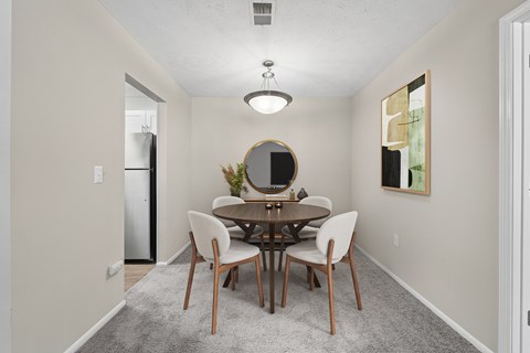 Dedicated dining area with seating for four and open access to kitchen at Edgemont Apartments, PRG Real Estate, Greenville, 29615