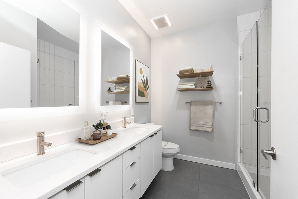 A modern bathroom with a white countertop and a white sink.