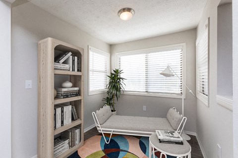 a living room with a couch and a table and a window