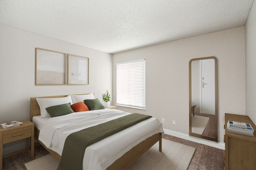 a bedroom with a bed and a mirror at The Reserve At Barry Apartments, Kansas City, MO, 64154