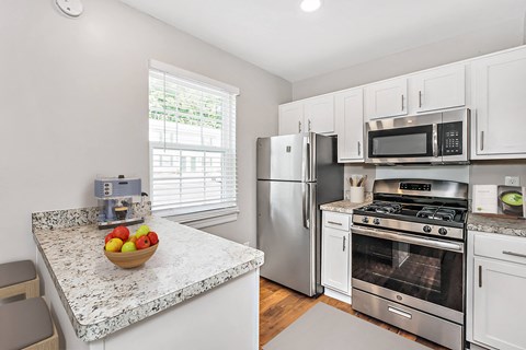 a kitchen with stainless steel appliances and a granite counter top