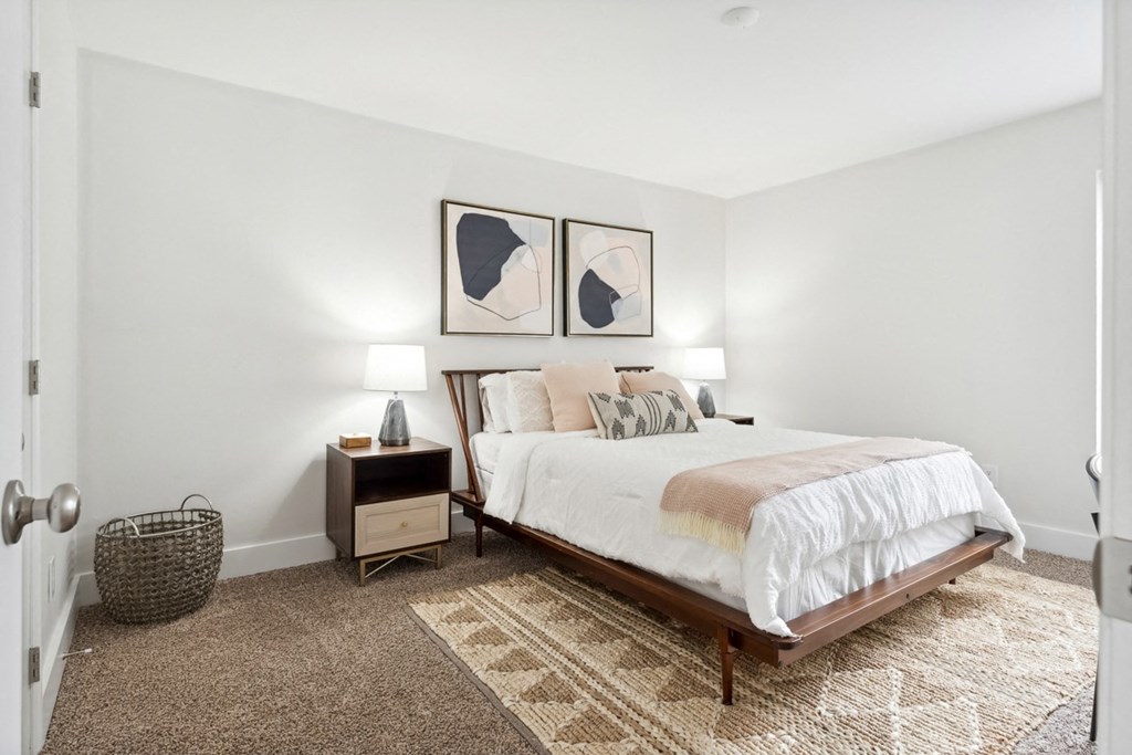 a bedroom with a bed and two night stands with lamps at Linkhorn Bay Apartments, Virginia, 23451