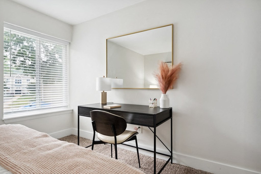 a bedroom with a bed and a desk with a mirror at Linkhorn Bay Apartments, Virginia, 23451