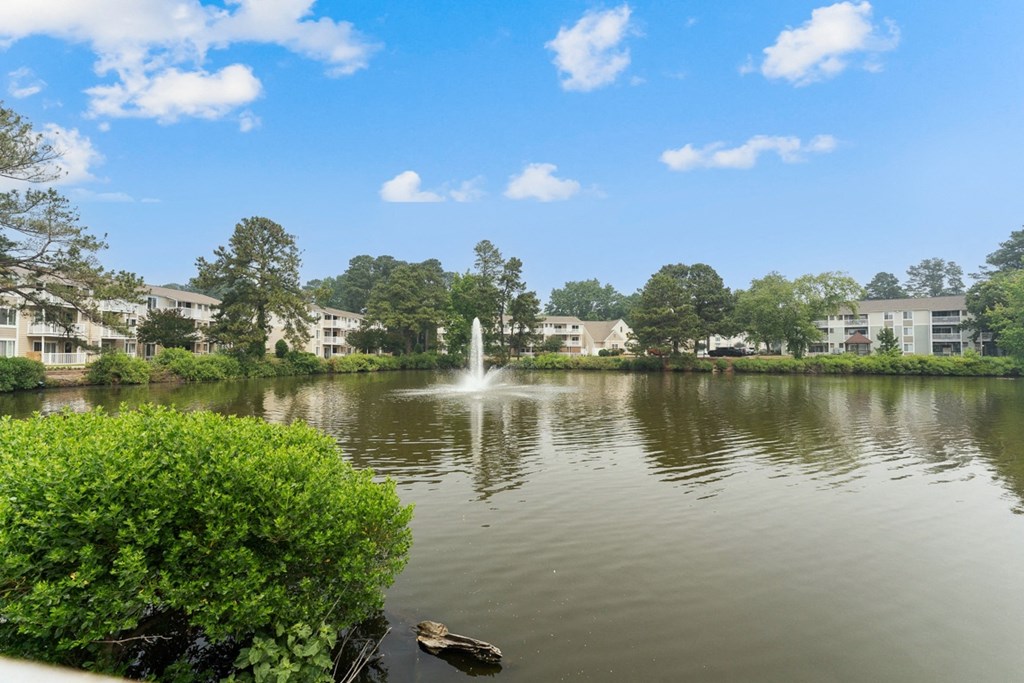 a fountain in the middle of a lake with apartment buildings in the background at Linkhorn Bay Apartments, Virginia Beach, VA, 23451