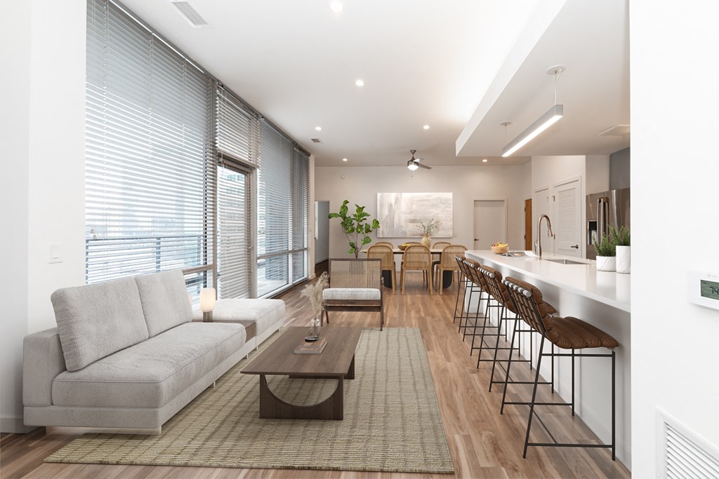 A modern living room with a grey sofa and a coffee table.