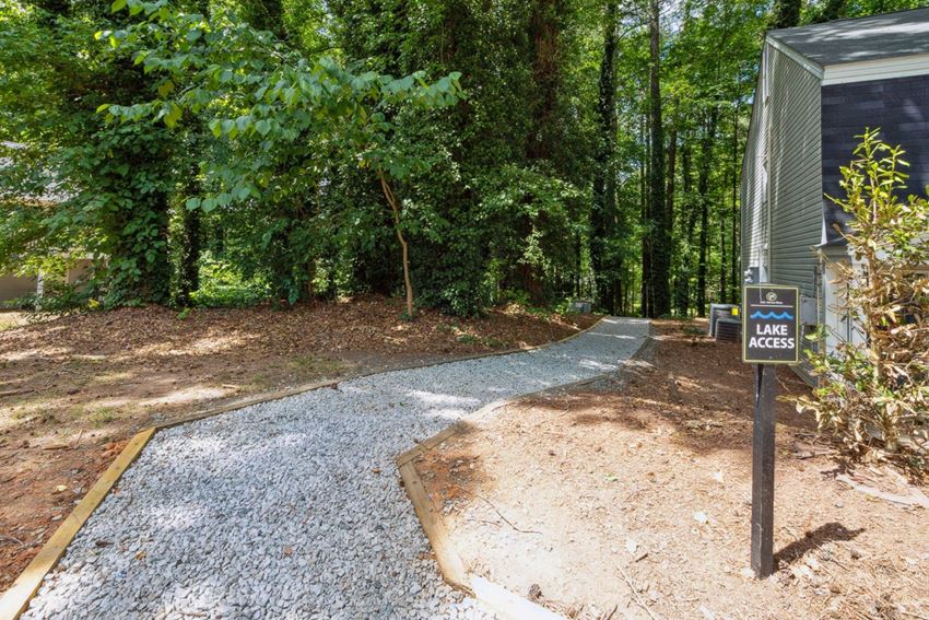 a path leading to a campsite in a wooded area a path leading to a campsite in a wooded area at Lake Johnson Mews, Raleigh, 27606